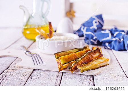 Baked crispy eggplant sticks served with white sauce. Vegetarian healthy dish. 136203661