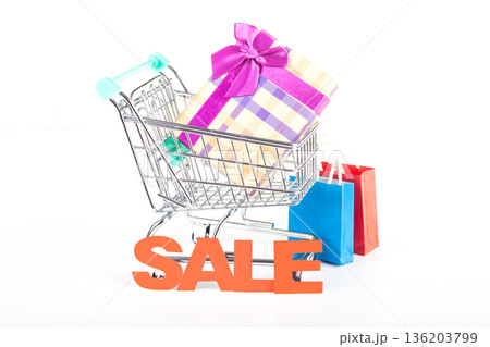 Holiday shopping cart filled with gift boxes and sale packages Holiday shopping cart filled with gift boxes and sale packages 136203799