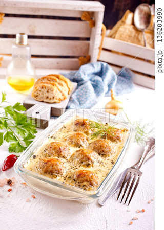 Italian casserole of baked meatballs in spicy white sauce with mozzarella cheese Italian casserole of baked meatballs in spicy white sauce with mozzarella cheese 136203990
