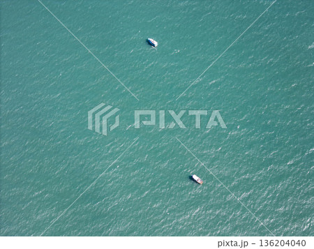 Small fishing boats on blue sea water Small fishing boats on blue sea water 136204040