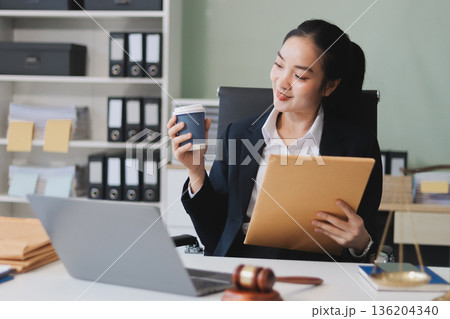 Lawyer explained to the client about the law that must be brought against the court case. Lawyer explained to the client about the law that must be brought against the court case. 136204340
