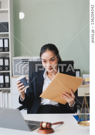 Lawyer explained to the client about the law that must be brought against the court case. Lawyer explained to the client about the law that must be brought against the court case. 136204342