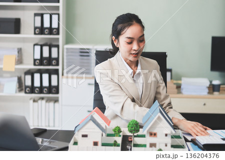 real estate agent home miniature model on documents sale and purchase of apartment notarial deed real estate agent home miniature model on documents sale and purchase of apartment notarial deed 136204376