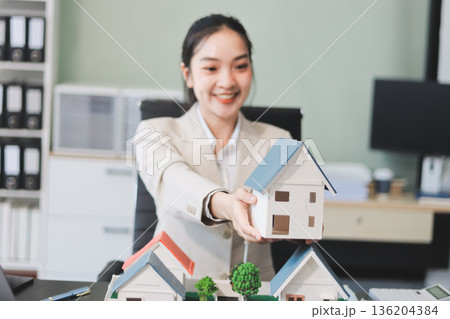 real estate agent home miniature model on documents sale and purchase of apartment notarial deed 136204384