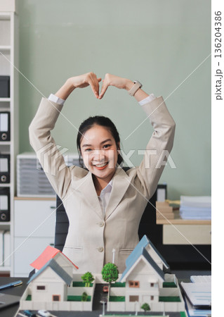 real estate agent home miniature model on documents sale and purchase of apartment notarial deed 136204386