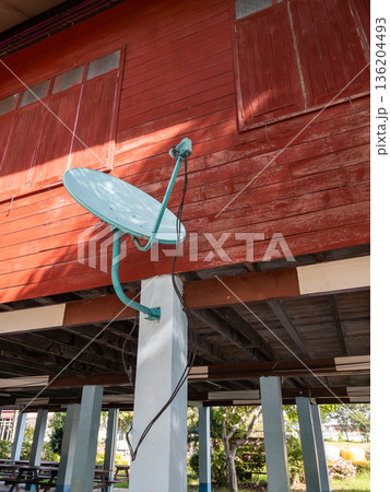 Satellite Dish for Distance Learning on the Wooden wall of a rural School. Satellite Dish for Distance Learning on the Wooden wall of a rural School. 136204493