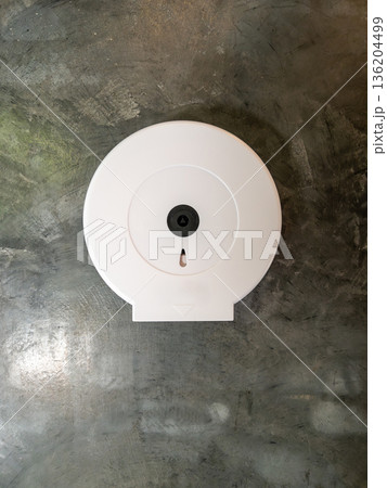 Modern White Tissue Dispenser on Polished Loft Concrete Wall. Modern White Tissue Dispenser on Polished Loft Concrete Wall. 136204499