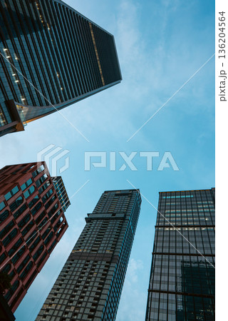 tall skyscrapers buildings looking up perspective, downtown district modern architecture of steel and glass, skyline of big city, low angle look-up view 136204564