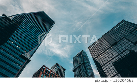tall skyscrapers buildings looking up perspective, downtown district modern architecture of steel and glass, skyline of big city, low angle look-up view 136204565
