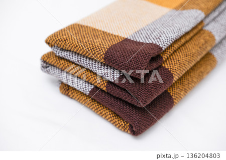 Brown plaid scarf on a light background Brown plaid scarf on a light background 136204803