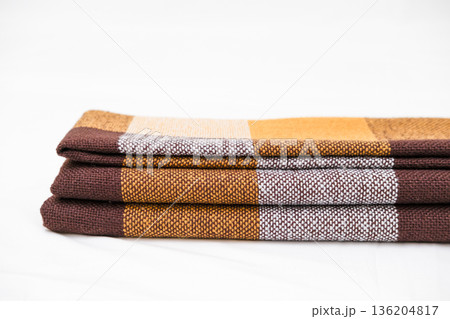 Brown plaid scarf on a light background 136204817