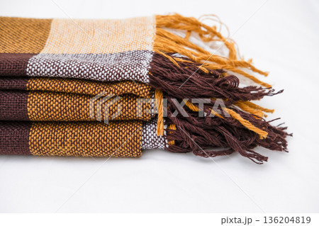 Brown plaid scarf on a light background Brown plaid scarf on a light background 136204819