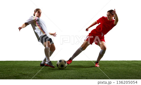 Women soccer players competing for ball on white background. 136205054