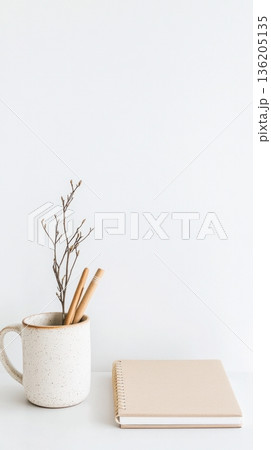 white desk with notebook, pencil and cup of tea 136205135