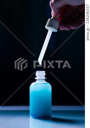 Close up of Blue Copper Peptides GHK-Cu in Pipette. Beauty serum for anti aging beauty routine Close up of Blue Copper Peptides GHK-Cu in Pipette. Beauty serum for anti aging beauty routine 136206357