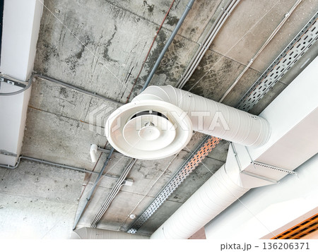 Ceiling Mounted Cassette Air Conditioner with Exposed Ductwork, Modern HVAC System in Commercial Building Interior, Air Conditioning Unit Ceiling Mounted Cassette Air Conditioner with Exposed Ductwork, Modern HVAC System in Commercial Building Interior, Air Conditioning Unit 136206371