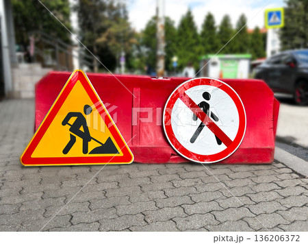 Warning traffic sign of construction works are happening. Yellow triangle symbol of working man. Restriction sign of safety zone 136206372