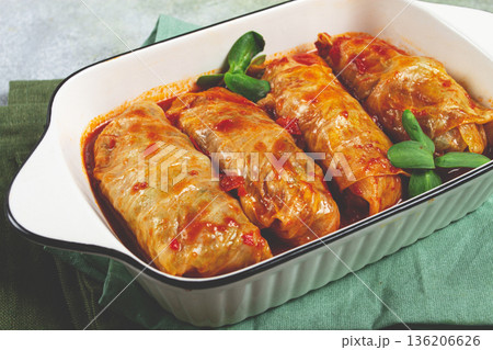 Stuffed cabbage rolls with minced meat, in tomato sauce, top view, without people, in the spotlight. 136206626