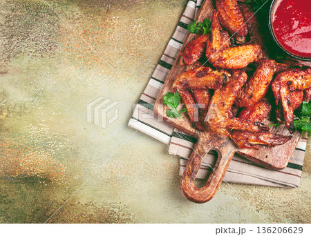 fried in the oven, chicken wings, with spices, tomato sauce, on a cutting board, gray background, no people, homemade, fried in the oven, chicken wings, with spices, tomato sauce, on a cutting board, gray background, no people, homemade, 136206629