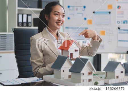 real estate agent home miniature model on documents sale and purchase of apartment notarial deed real estate agent home miniature model on documents sale and purchase of apartment notarial deed 136206872