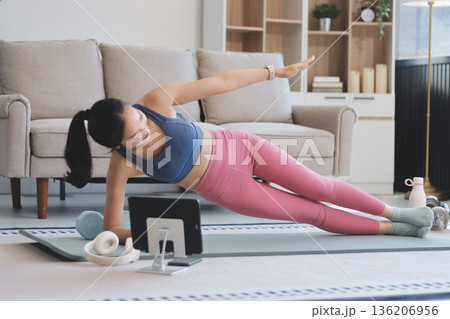 Young Asian sporty attractive people practicing yoga lesson with instructor. Asia group of women exercising healthy lifestyle in fitness studio. Sport activity, gymnastics or ballet dancing class. Young Asian sporty attractive people practicing yoga lesson with instructor. Asia group of women exercising healthy lifestyle in fitness studio. Sport activity, gymnastics or ballet dancing class. 136206956