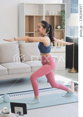 Young Asian sporty attractive people practicing yoga lesson with instructor. Asia group of women exercising healthy lifestyle in fitness studio. Sport activity, gymnastics or ballet dancing class. Young Asian sporty attractive people practicing yoga lesson with instructor. Asia group of women exercising healthy lifestyle in fitness studio. Sport activity, gymnastics or ballet dancing class. 136206957