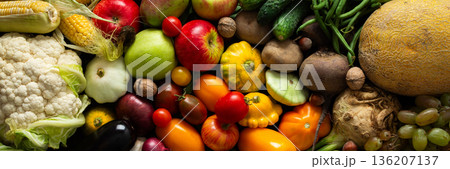 Fresh vegetables and fruits are arranged on a dark surface, showing a variety of colors and shapes. This was captured after a recent harvest from a local farm, banner Fresh vegetables and fruits are arranged on a dark surface, showing a variety of colors and shapes. This was captured after a recent harvest from a local farm, banner 136207137