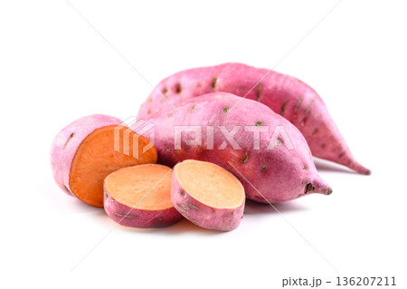 Sweet potato with cut slices on white surface 136207211