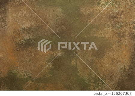 A textured surface with worn coloring appears in the frame. Ochre, green, tan, and brown shades mix to create an abstract design with a rugged feel A textured surface with worn coloring appears in the frame. Ochre, green, tan, and brown shades mix to create an abstract design with a rugged feel 136207367