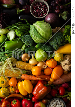 A collection of fresh vegetables and fruits fills the table with various colors. Farmers gather to showcase their harvest. Customers browse and select produce for their meals A collection of fresh vegetables and fruits fills the table with various colors. Farmers gather to showcase their harvest. Customers browse and select produce for their meals 136207395