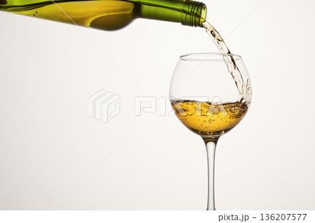 Degustation, examination of white wine in elegant glass. Degustation, examination of white wine in elegant glass. 136207577
