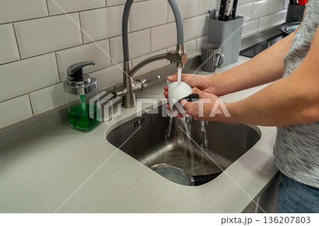 Middle age man washing dishes Middle age man washing dishes 136207803