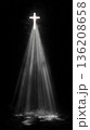 Radiant cross emerges from darkness, casting beams of light in harmony 136208658