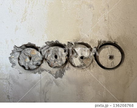 Wall with circular holes for electrical wiring installation in renovation project background Wall with circular holes for electrical wiring installation in renovation project background 136208768