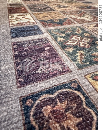 Patchwork carpet pattern with varied floral designs in a textured background 136208782