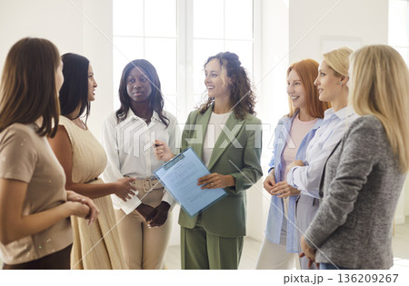 Team training workshop with women group engaged in coaching and discussion 136209267