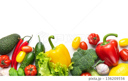 Fresh healthy vegetables creating nutritious food border on white Fresh healthy vegetables creating nutritious food border on white 136209556