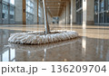 朝日が差すオフィスロビーで床を拭くモップの接写、人物なし、清潔感の情景 136209704