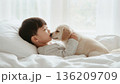 日本人の男の子と小型犬を白い余白に溶かし込む高キーな安らぎの寝顔 136209709