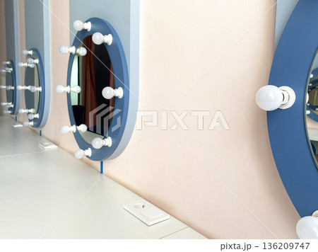 Stylish makeup vanity with circular mirrors and bright bulbs, showcasing a modern design aesthetic, perfect for beauty routines and personal grooming spaces Stylish makeup vanity with circular mirrors and bright bulbs, showcasing a modern design aesthetic, perfect for beauty routines and personal grooming spaces 136209747
