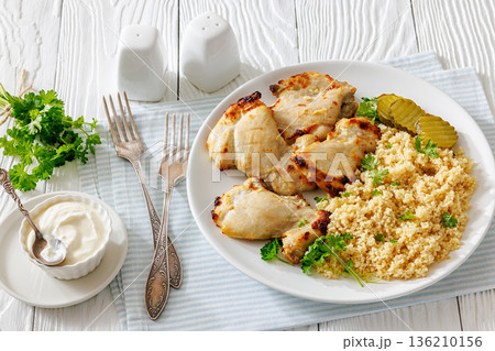 Boneless chicken thighs and couscous on a plate Boneless chicken thighs and couscous on a plate 136210156