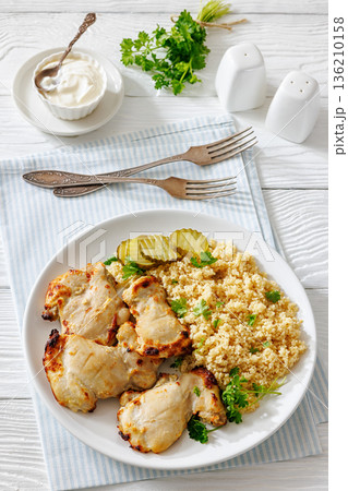 Boneless chicken thighs and couscous on a plate Boneless chicken thighs and couscous on a plate 136210158