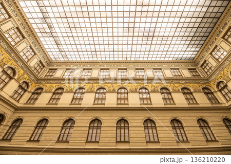 The ceiling of the National Museum in Prague shows intricate designs and bright lights. Visitors can see the artfully arranged glass and structure above while exploring the museum. The ceiling of the National Museum in Prague shows intricate designs and bright lights. Visitors can see the artfully arranged glass and structure above while exploring the museum. 136210220