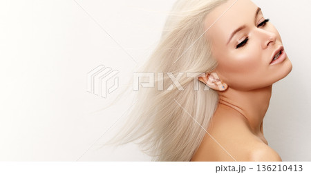 Graceful Woman With Flowing Hair. Serene Blonde Woman Radiating Calm, Effortless Charm In Motion. Caucasian Woman With Windblown Hair And Glowing Skin Exudes Peaceful Elegance And Grace. Blond Beauty 136210413