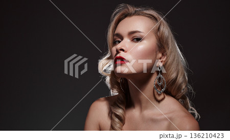 Blonde Caucasian Woman Shoulders Bared Commanding Gaze, Fashion Editorial Styling, Glossy Red Lips, Oversized Earrings, Sculpted Collarbone, Dramatic Lighting, Sophisticated Eveningwear Vibe 136210423