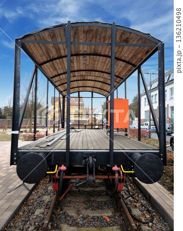 A restored wooden railway platform car on the tracks A restored wooden railway platform car on the tracks 136210498
