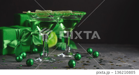 Green Cocktails with Lime,  Gifts and Confetti. Festive St. Patricks Day Celebration Still Life 136210805