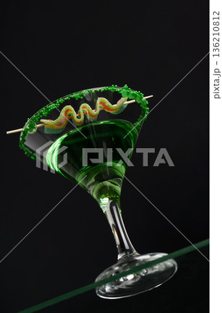 Green Cocktails with Rainbow Candy and Shamrocks. Festive St. Patricks Day Celebration Still Life. Low angle View Green Cocktails with Rainbow Candy and Shamrocks. Festive St. Patricks Day Celebration Still Life. Low angle View 136210812