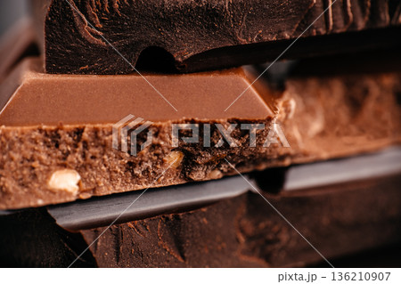 Chocolate bar pieces with nut filling, macro close up Chocolate bar pieces with nut filling, macro close up 136210907