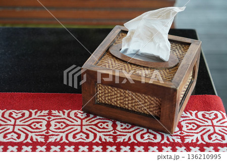 top view the tissues are in a rectangular wooden box. on the red carpet On the black marble table, nature background, object, decor, copy space top view the tissues are in a rectangular wooden box. on the red carpet On the black marble table, nature background, object, decor, copy space 136210995